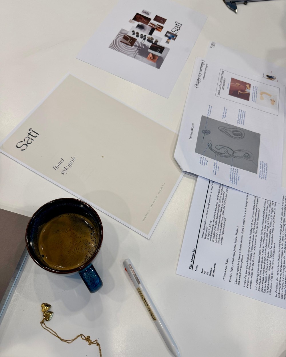 Sati brand materials and sketches on a desk, part of the design process