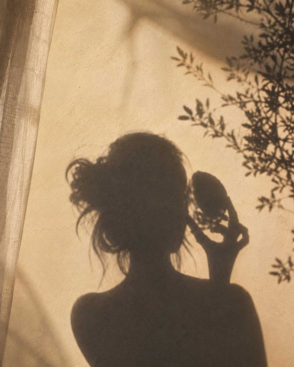 A woman's silhouette in warm evening light, a quiet closing moment
